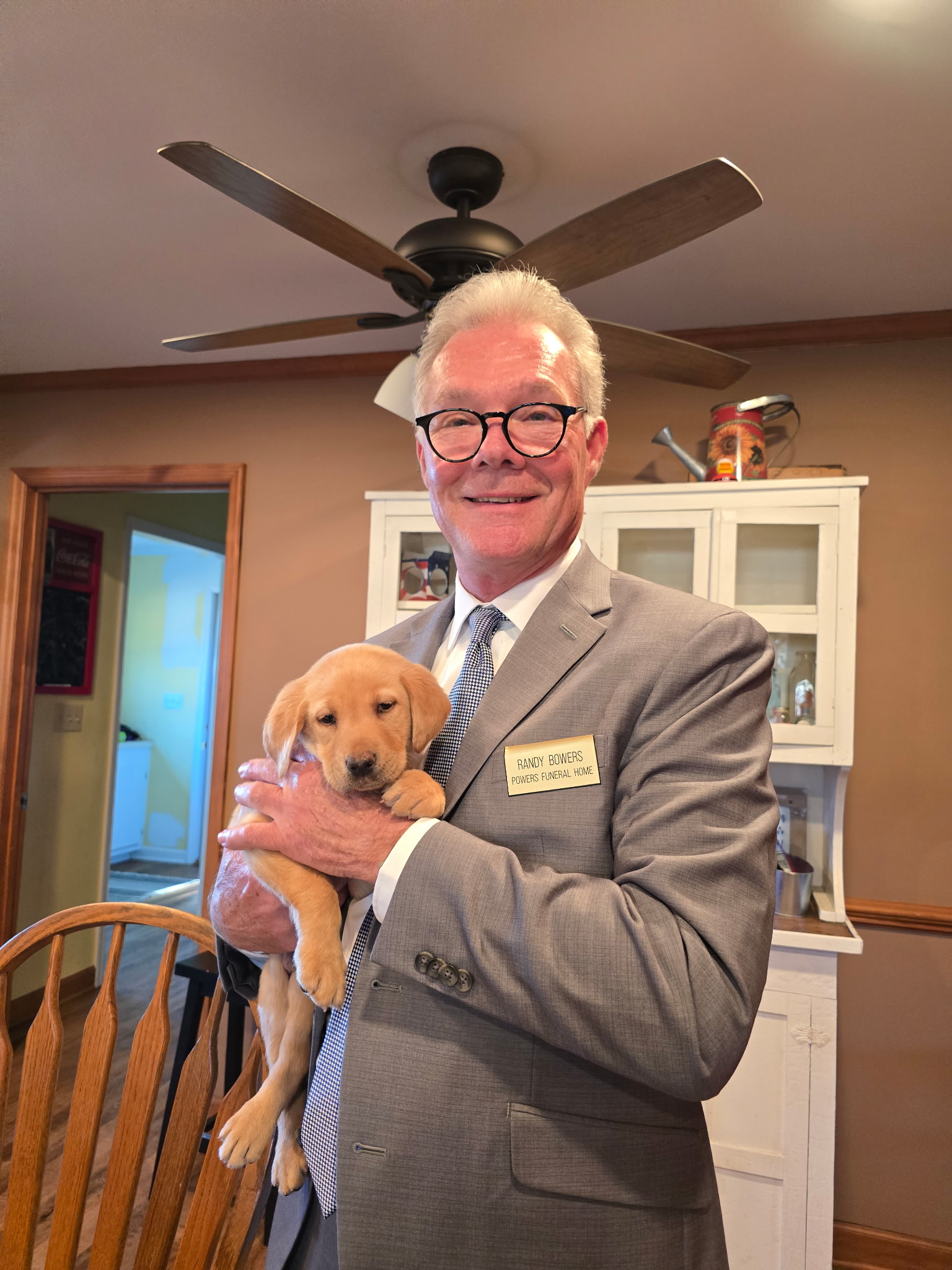 Client holding a yellow Labrador puppy at Seegars Mill Kennels